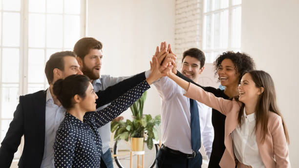 istock Cheerful multiethnic team of young professionals giving group high five 2197752189