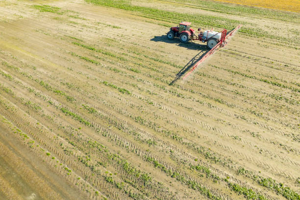 istock Agricultural crops sprayer in a wheat field seen from above 2197752631