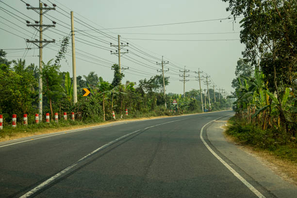 istock Peaceful road surrounded by green trees. This type of road 2197752853