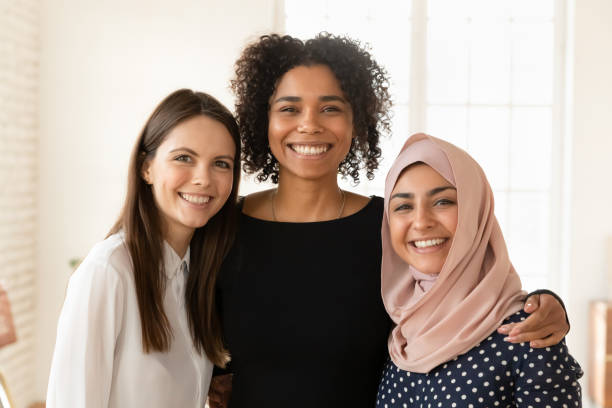 istock Three cheerful multicultural office colleague friends standing together 2197753193