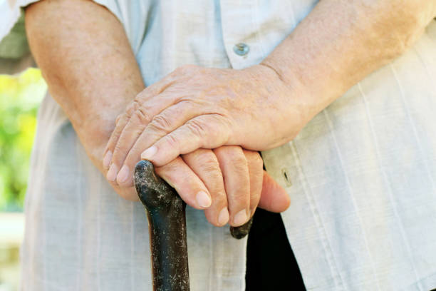 istock Hands of old senior with walking stick 2197753413
