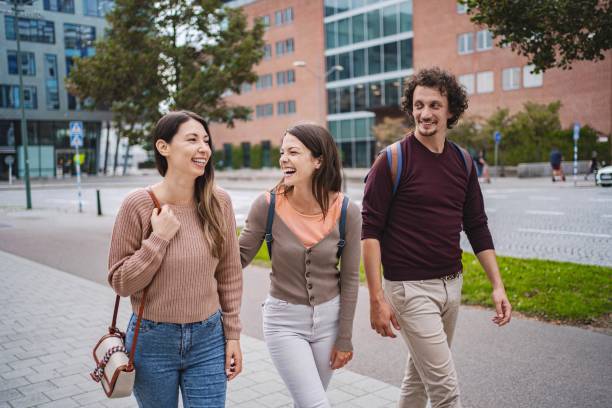 istock Three happy students walking and chatting together in malmo 2197753742