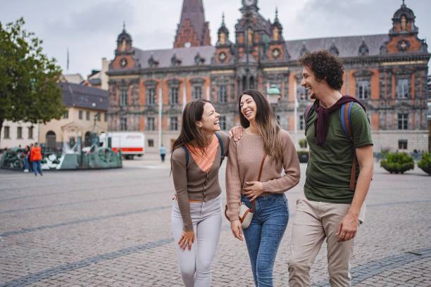 istock Tourists walking and laughing in stortorget square, malmo, sweden 2197753751