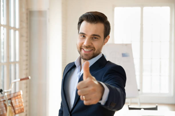 istock Positive young Caucasian business coach man making like hand 2197754012