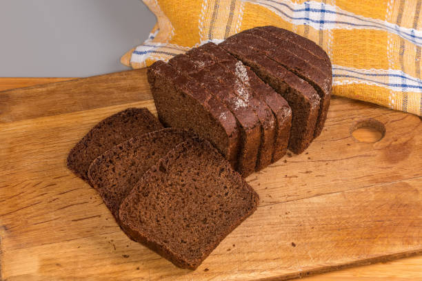 istock Sliced dark rye and wheat brown bread on cutting board 2197754592