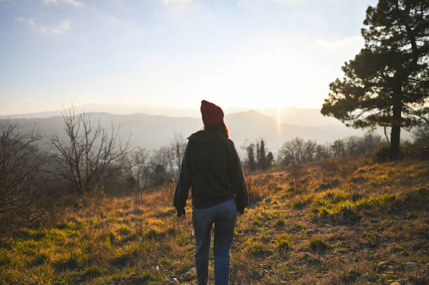 istock Woman at sunset meadow. 2197756346