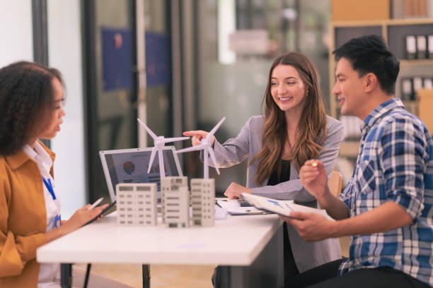 istock A sales representative gives a presentation on how solar cells work to her co-workers at the office. Meeting of a team of renewable energy engineers working on a solar panel battery concept. 2197756695