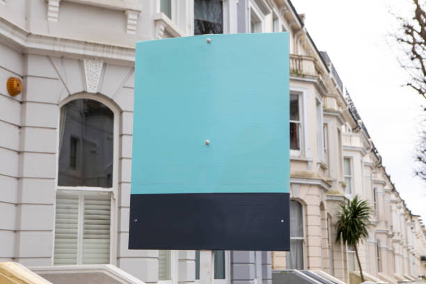istock Estate agent board with copy space outside terraced houses 2197758651