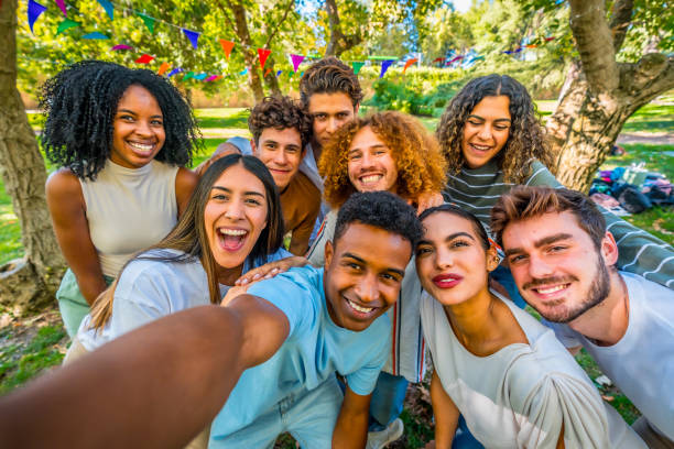 istock Happy multi-ethnic students taking a selfie in a park during a college party 2197759375