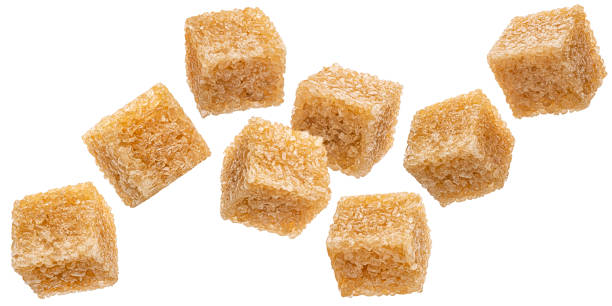 istock Falling cubes of cane sugar isolated on white background 2197760440