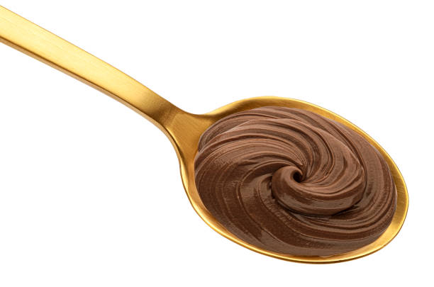 Chocolate cream in golden spoon isolated on white background with clipping path, top view