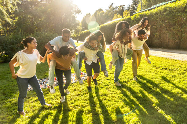 istock Friends playing piggyback race in park at sunset 2197760614