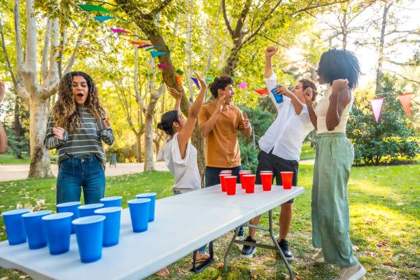 istock Young people playing beer pong in the park 2197760783