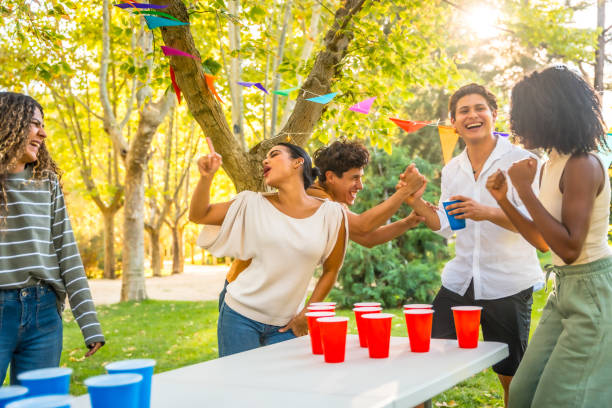 istock Friends playing beer pong at a park party 2197760844