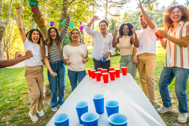 istock Young people playing beer pong outdoors and cheering 2197761001