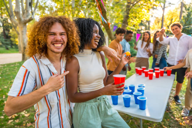istock Young people playing beer pong at a park party 2197761316