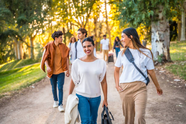 istock Group of students walking and talking in a park during autumn 2197761454