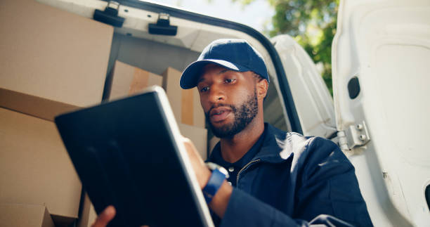 istock Courier, boxes or man with tablet by van for package distribution, online order checklist or inventory inspection. Logistics, transport or black driver with digital app for parcel location or service 2197762758
