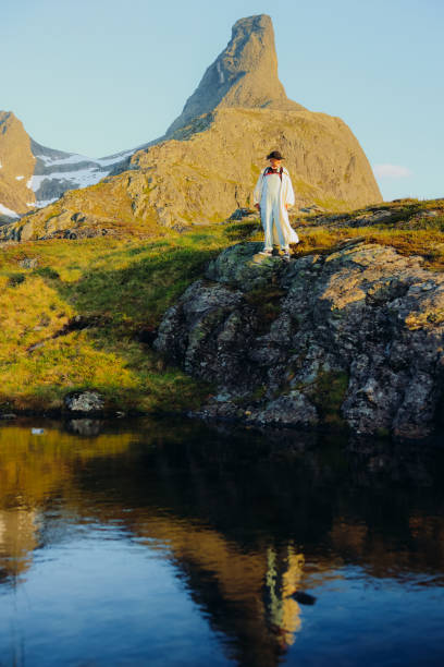istock Hiker Admiring Sunset Views Over Reflection Lake on Litlefjellet Mountain, Norway 2197763440