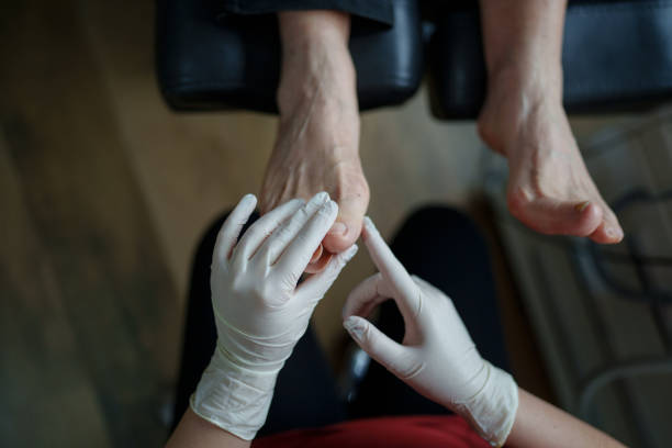 Podiatrist examining patient's bunion.