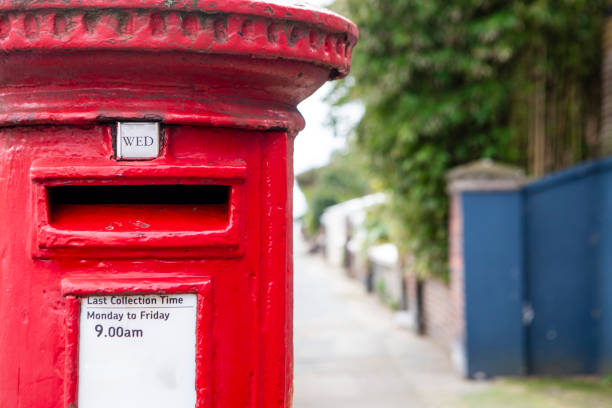 istock Red postbox on a residential street 2197764062