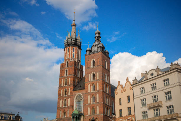 This image depicts St. Mary’s Basilica, one of Krakow's most iconic landmarks, located in the Main Market Square. The architecture includes Gothic details and towers. Taken on April 28, 2022
