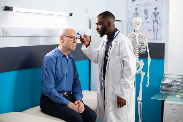 istock Doctor checks temperature of elderly man 2197767280