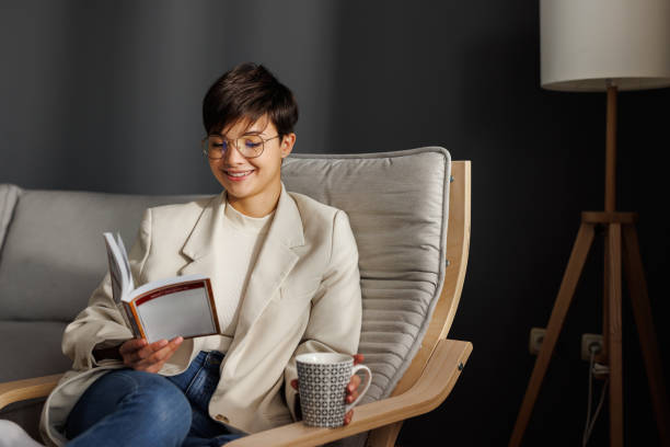 istock Young professional relaxing with book and coffee 2197767942