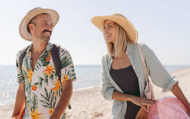 istock Smiling couple arriving at the beach 2197768247