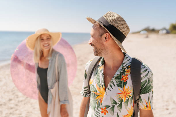 istock Smiling couple arriving at the beach 2197768251