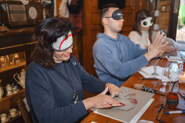 istock Patients modeling clay during psychotherapy session with sleep masks 2197771590