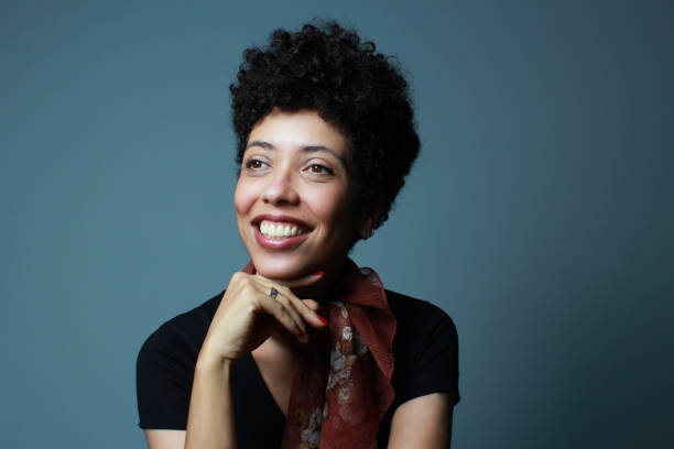istock Friendly brown skin woman smiling and looking sideways. 2197772879