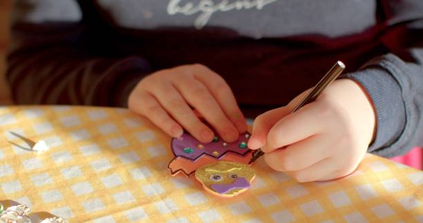istock Easter eggs painting. Family gathers around the table, preparing for Easter 2197773779