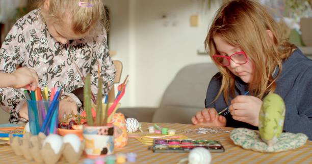 istock Easter eggs painting. Family gathers around the table, preparing for Easter 2197775457