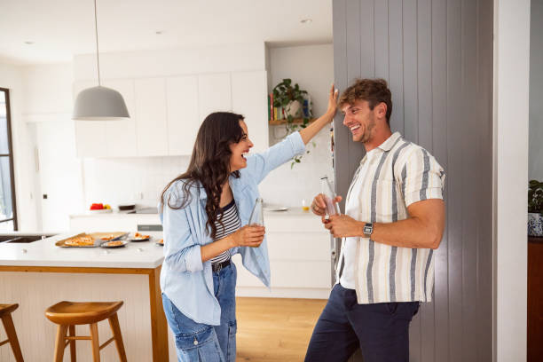 istock Young Couple Enjoying Drinks Together at a Home Kitchen 2197777410
