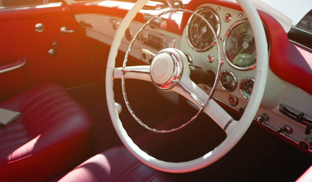 istock Vintage car interior with classic steering wheel. 2197778484