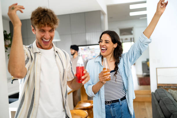 istock Young Friends Enjoying a Party Celebration Inside a Modern Living Space 2197779651