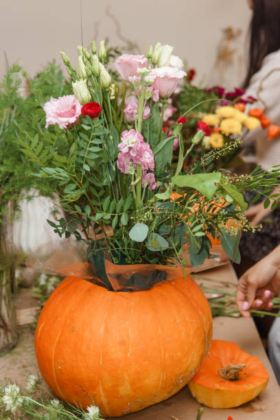 istock Creating a floral composition in a pumpkin. Making decor with your own hands. 2197780454
