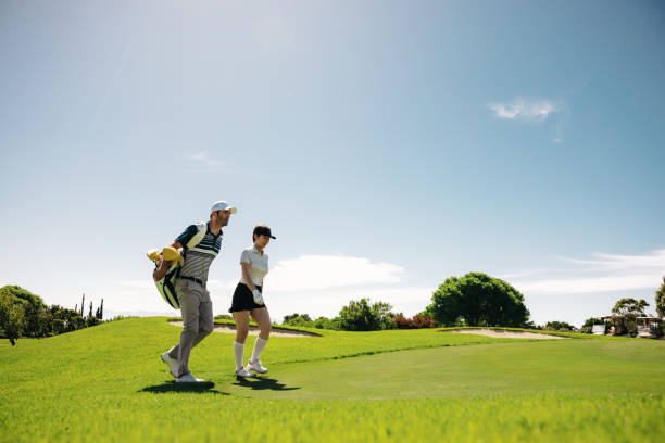 istock Female golf player walking with golf gear on the fairway 2197781557