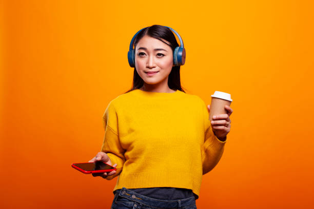 istock Woman holding phone and coffee cup 2197786961