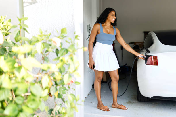 Black woman charging her car