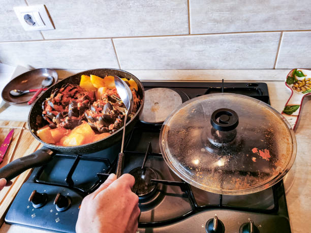 istock Cooking Artichoke and Potato in Tomato Sauce 2197787429