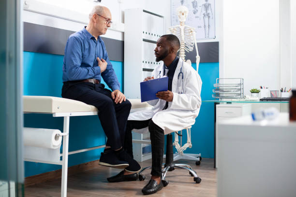 istock Doctor with clipboard listens to patient 2197789229