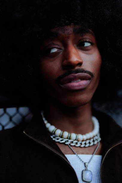 istock Young man with afro hair looking away 2197789572
