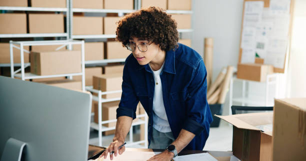 istock Box, computer and delivery with business man in office for distribution or logistics planning. Ecommerce, retail and typing with employee at desk in workplace for online supply chain management 2197790688