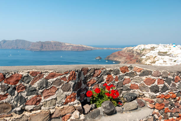 Amazing view to Aegean Sea from beautifully decorated with succulents rooftop terrace of a cave house/cliff dwelling on the picturesque Santorini island Caldera edge,Cyclades Greece.
