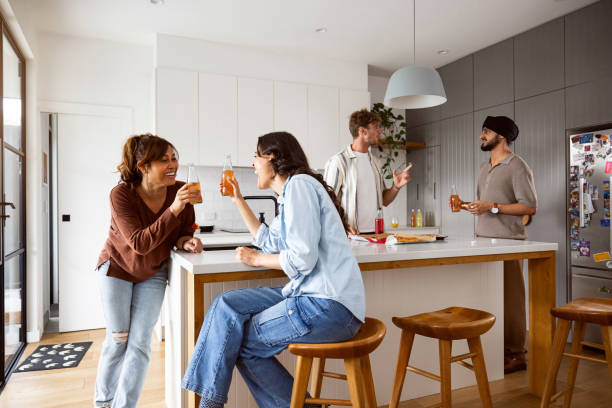 istock Young Friends Enjoying Casual Gathering in a Modern Kitchen 2197791564