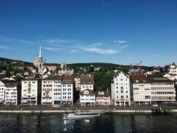 Swiss buildings in Zurich Switzerland on the river with church in background