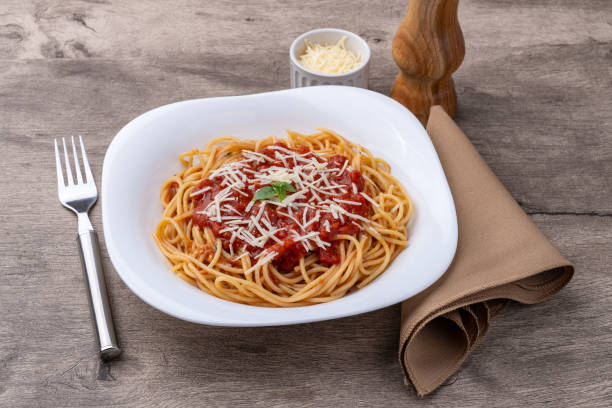 istock Spaghetti pasta in a plate with tomato sauce and parmesan cheese 2197793838