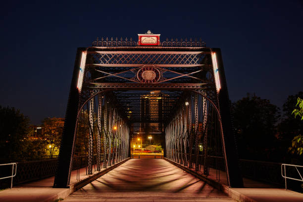 Illuminated Wells Street Bridge at twilight, showcasing historical architecture in downtown Fort Wayne.
